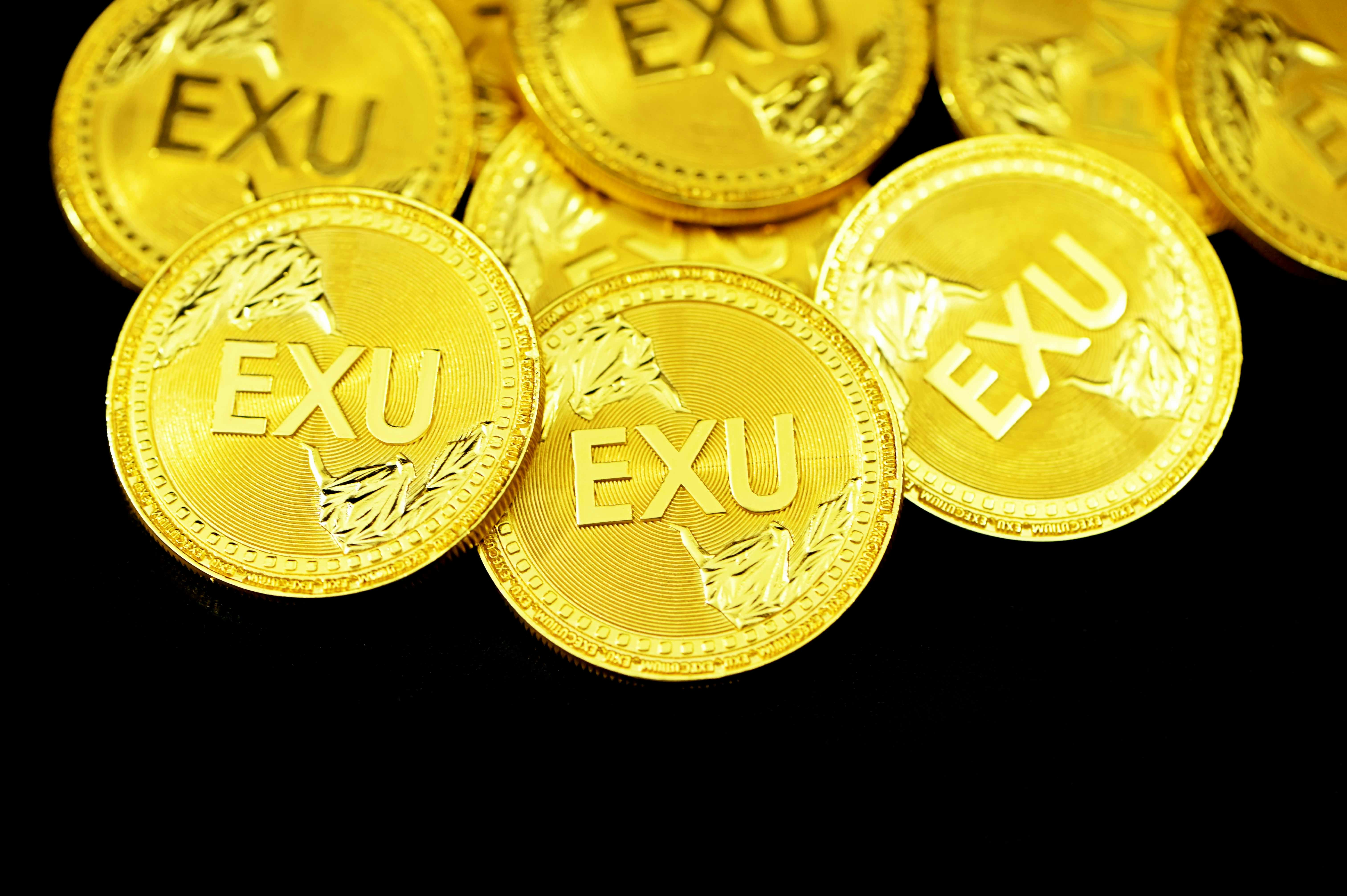 EXU coins on a black surface